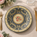 Slate blue charger plate with gold trim featuring layered gold scrollwork and a rose medallion