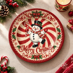 White charger plate with gold trim featuring a snowman on a peppermint swirl and holly border
