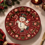 Red charger plate with gold trim featuring a snowman between radiating candy canes and snowflakes