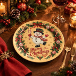 Cream charger plate with gold trim featuring a snowman inside a fir wreath and a red ribbon bow