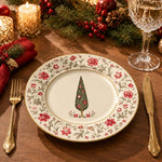 Cream charger plate with gold trim featuring a vintage tree framed by a trailing rose border