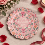 Pink scalloped plate with Valentine's Day script inside a heart wreath