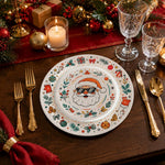 * Christmas charger plate styled on a festive holiday dinner table setting with holiday greenery and candles.