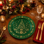 * Green Christmas charger plate styled on a festive holiday dinner table setting with candles and pine cones.