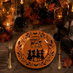 * Orange plating charger plates styled on an elegant autumn dining table with linen napkins and candles.