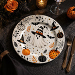 * Minimalist white charger plate with abstract black and grey paint stroke design, flat top-down view.