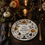* A white bird charger plate styled on a dark dining table with a black bowl and chopsticks for an Asian-themed dinner.