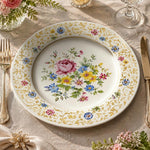 * Vintage floral charger plate featuring a pink rose bouquet, wildflowers, and an intricate gold scrollwork rim on cream.
