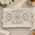 Ivory white tray with gold trim featuring a blue rosette medallion and acanthus scrolls