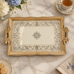 Warm cream tray with gold trim featuring a blue and gold baroque scroll border
