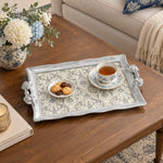 Silver white tray with gold trim featuring a dense repeat of blue flowering sprigs