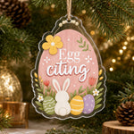 Pink egg acrylic hanging wall decor with white bunny, pastel Easter eggs, yellow flower, and Egg-citing text on jute twine.