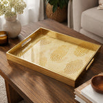 Fingerprint Art Glass Serving Tray – Gold Topographic on a coffee table, featuring UV-printed artwork on tempered glass with an electroplated frame and matching handles.