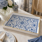 White tray with gold trim featuring blue and white Delft-inspired floral medallion pattern