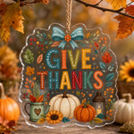 Give Thanks acrylic hanging wall decor with pumpkin, teal bow, candle lantern, and clear die-cut edge.