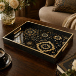 Islamic Geometric Serving Tray with Black Frame and Gold Medallions | Minti Home on a coffee table, featuring UV-printed artwork on tempered glass with an electroplated frame and matching handles.