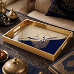 Islamic Glass Serving Tray – Blue Mandala & Arabic Calligraphy on a coffee table, featuring UV-printed artwork on tempered glass with an electroplated frame and matching handles.