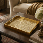 Vintage Gold Damask Arabesque Glass Serving Tray, 40x30cm styled on a console table with a ceramic mug and books beside a brass lamp.