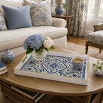 White tray with gold trim featuring blue and white Delft-inspired floral medallion pattern