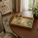 Indian Elephant Glass Serving Tray – Gold Floral Scrollwork displayed on a dining table with a porcelain teapot and fresh flowers, vintage cabinet in background.