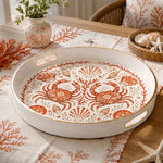White tray with gold trim featuring decorative crab seashell and coral coastal pattern on warm ivory ground
