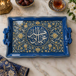 Royal blue tray with gold trim featuring a circular Arabic calligraphy medallion framed by dense floral arabesque scrollwork