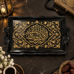 Black tray with gold trim featuring an arabesque calligraphy medallion and slim floral vines