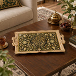 Black tray with gold trim featuring a gilded Arabic calligraphy medallion and floral vine border