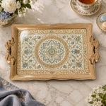 Champagne tray with gold trim featuring a scalloped rosette medallion and leafy floral vines