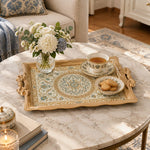 Champagne tray with gold trim featuring a scalloped rosette medallion and leafy floral vines