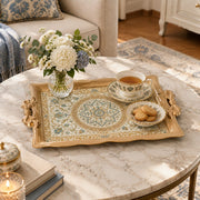 Champagne tray with gold trim featuring a scalloped rosette medallion and leafy floral vines