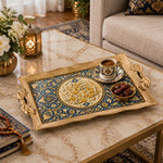 Antique gold tray with gold trim featuring a gold Arabic calligraphy medallion ringed by scrolling floral vines