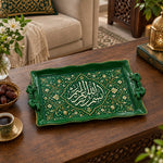 Emerald green tray with gold trim featuring a scalloped Arabic calligraphy medallion framed by leafy floral scrollwork