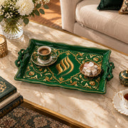 Dark green tray with gold trim featuring a gilded flame ornament in a lobed arch frame of floral scrollwork