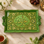 Green tray with gold trim featuring a lobed Arabic calligraphy medallion in dense floral scrollwork