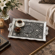 Silver and black tray with gold trim featuring a calligraphy medallion in a damask floral arch