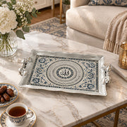 Silver white tray with gold trim featuring coiled indigo calligraphy rings and floral sprays