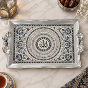 Silver white tray with gold trim featuring coiled indigo calligraphy rings and floral sprays