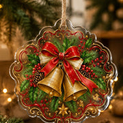 Clear acrylic hanging wall decor featuring a circular Christmas wreath with a candy cane bow, holly, and pinecones.
