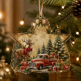 Star-shaped clear acrylic Christmas ornament featuring a vintage red truck, reindeer, and pine trees.