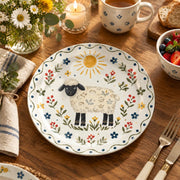 Daily Decorative Charger Plate – Folk Sheep Sun Field decorative charger plate on a styled table.