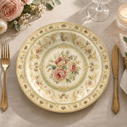 Ivory charger plate with gold trim featuring a pink rose medallion in a green ornamental border