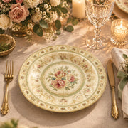 Ivory charger plate with gold trim featuring a pink rose medallion in a green ornamental border
