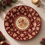 Burgundy charger plate with gold trim featuring a rose medallion and scattered fleur-de-lis sprigs