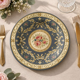 Slate blue charger plate with gold trim featuring layered gold scrollwork and a rose medallion