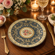 Slate blue charger plate with gold trim featuring layered gold scrollwork and a rose medallion