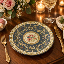Slate blue charger plate with gold trim featuring layered gold scrollwork and a rose medallion