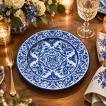 Navy blue charger plate with gold trim featuring white acanthus scroll medallion and leafy border