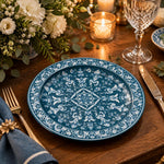 Teal blue charger plate featuring a white acanthus medallion and dense scrollwork border