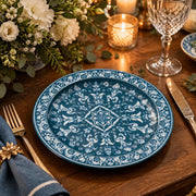 Teal blue charger plate featuring a white acanthus medallion and dense scrollwork border